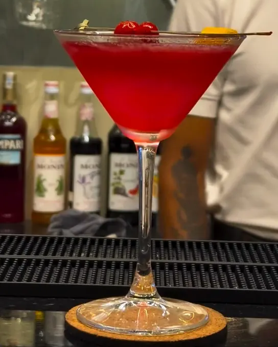 A red cosmopolitan in a martini glass