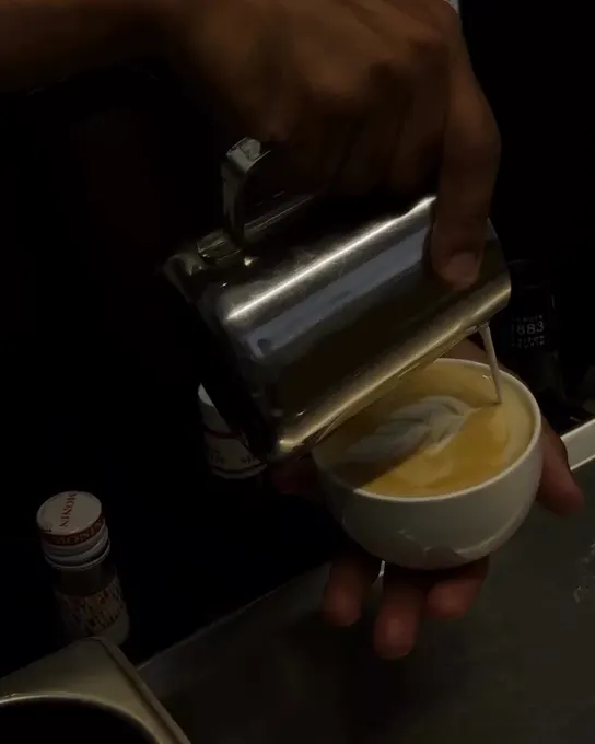 Milk being poured into a latte